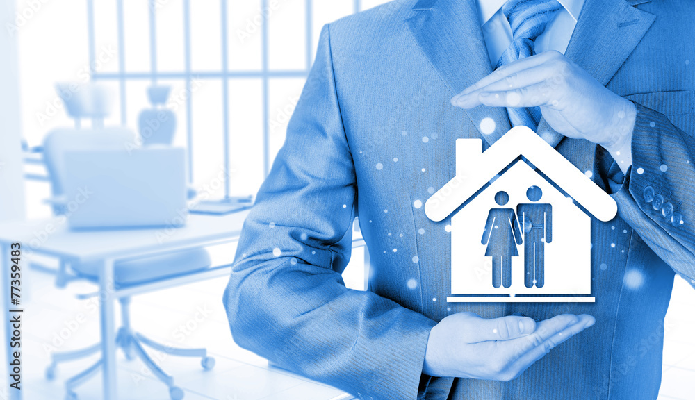 businessman protecting family in home with hands businessman protecting family in home with hands