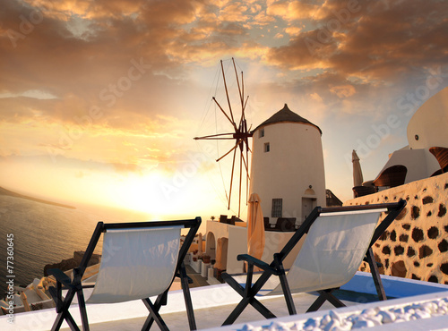 Windmill against colorful sunset, Santorini, Greece