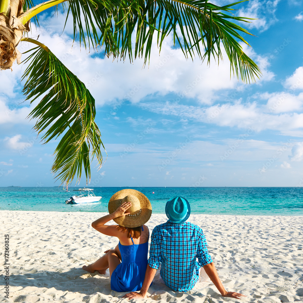 Couple in blue clothes on a beach at Maldives