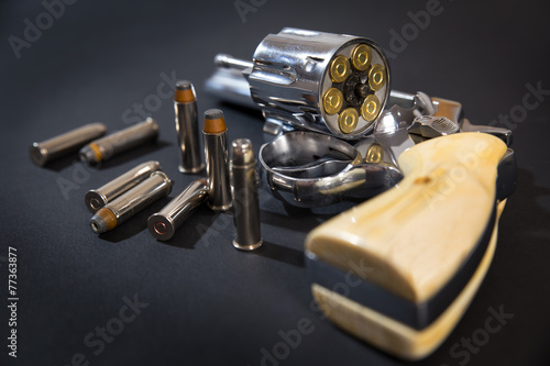 Wallpaper Mural A pistol with bullets on a black background. Torontodigital.ca