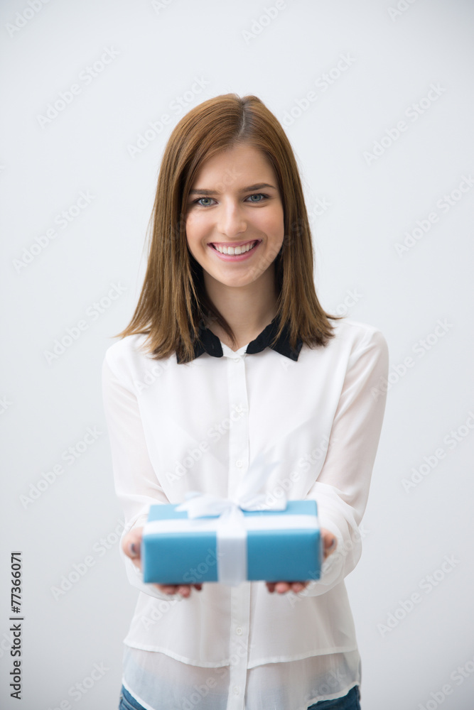 Portrait of a cheerful woman holding gift over gray background Portrait of a cheerful woman holding gift over gray background