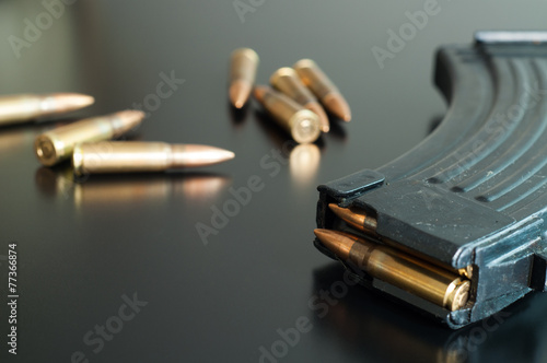 Fotografie Kalashnikov bullets on the table.