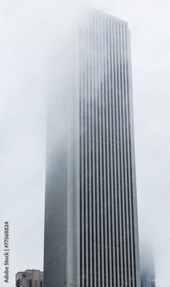 Fototapeta premium Tall Building Into Fog