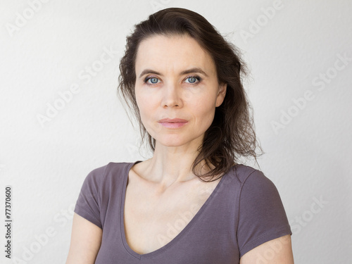 Woman thinking about, looking into camera