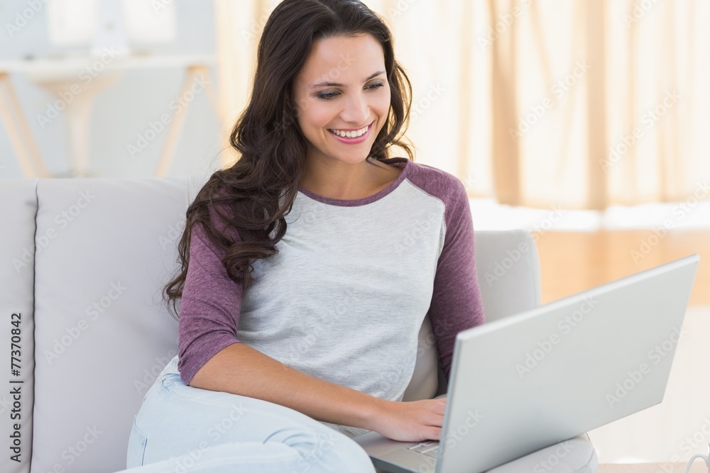 Pretty brunette using her laptop Pretty brunette using her laptop