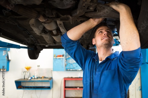 Mechanic examining under the car