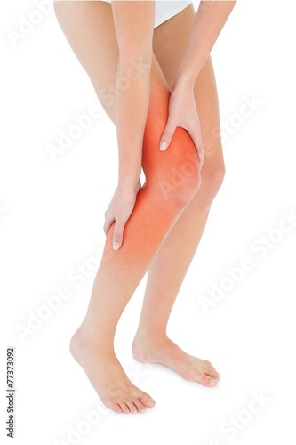 Closeup low section of a fit woman with leg pain