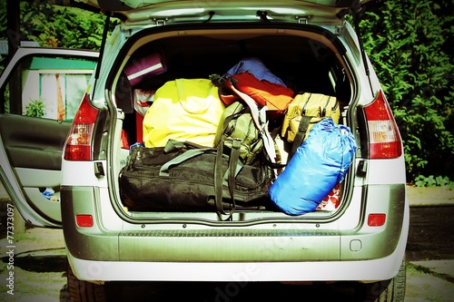 car with the trunk full of luggage and suitcases photo