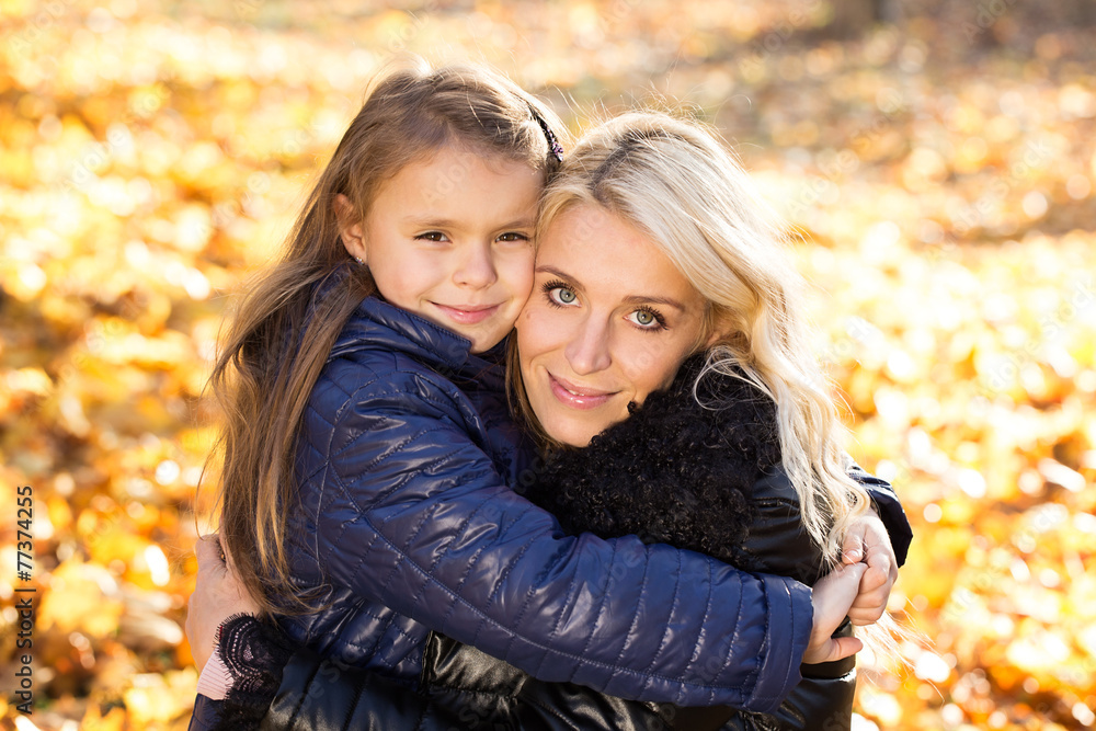 Fototapeta premium Daughter hugging her mother park