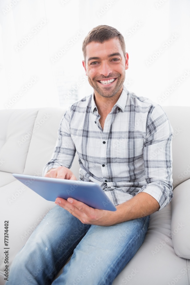 A smiling man using a tablet A smiling man using a tablet