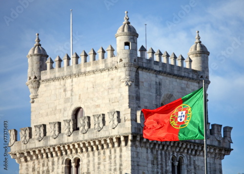 Belem Tower in Lisbon and Portuguese national flag 