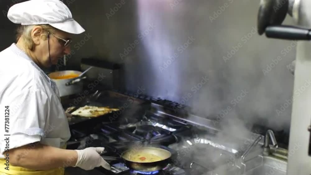 cook cooking pasta with anchovies at italian restaurant cook cooking pasta with anchovies at italian restaurant