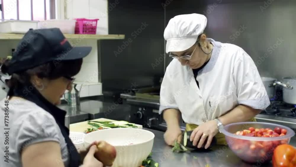 chef cook and cook's assistant cutting eggplant and apples chef cook and cook's assistant cutting eggplant and apples