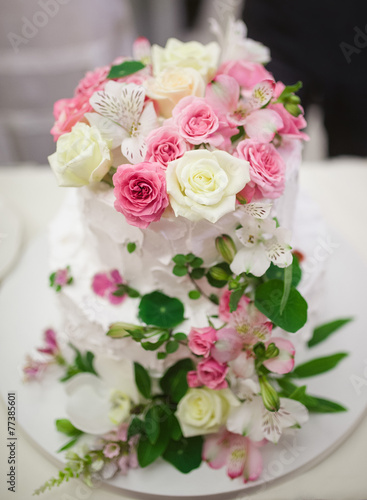 Wedding cake decorated with beautiful flowers.