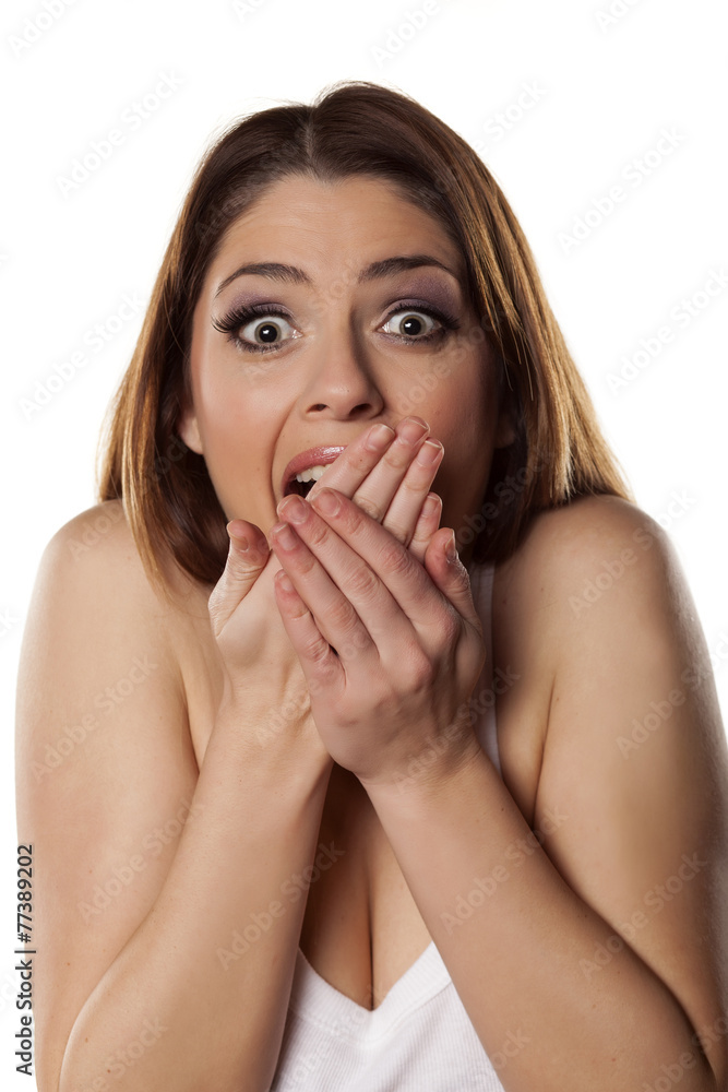 Young shocked woman covering her mouth with her hands Young shocked woman covering her mouth with her hands