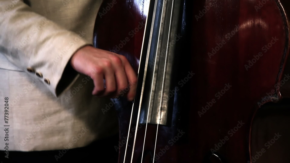 Close up pan shot of a bass player Close up pan shot of a bass player