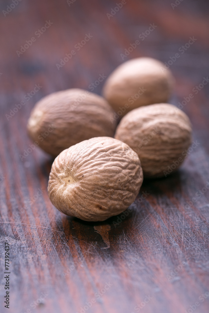 Ground nutmeg spice on the wooden background Ground nutmeg spice on the wooden background