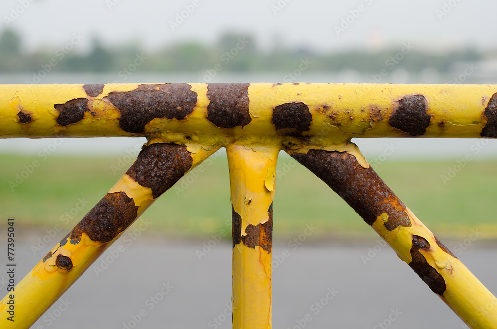 rusty yellow fence