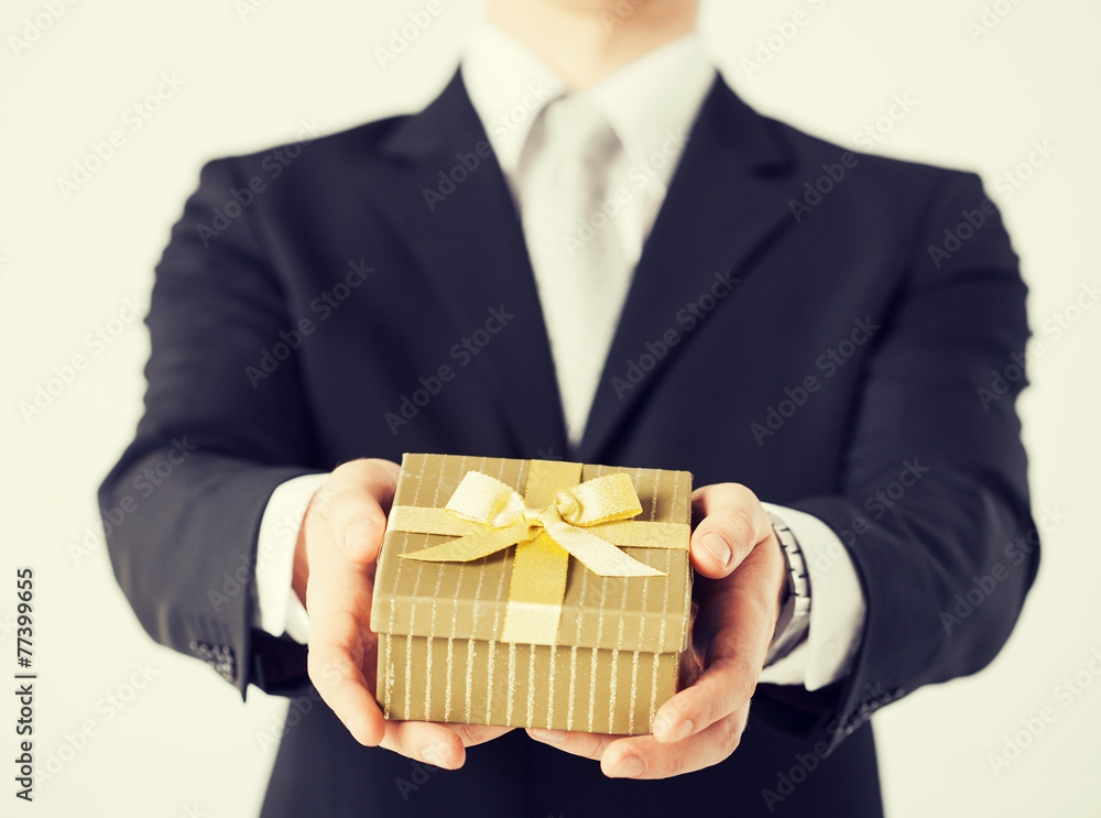 man hands holding gift box man hands holding gift box
