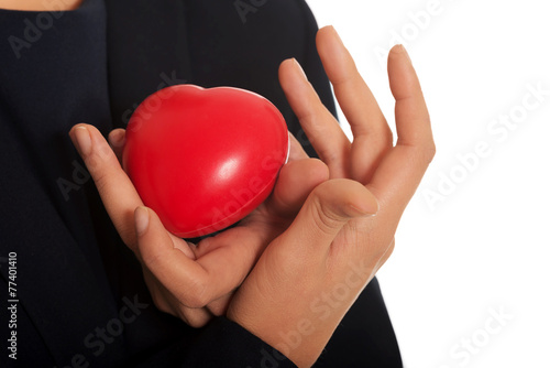 Businesswoman holding heart shaped toy