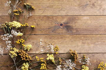 Dried flowers on rustic wooden planks background