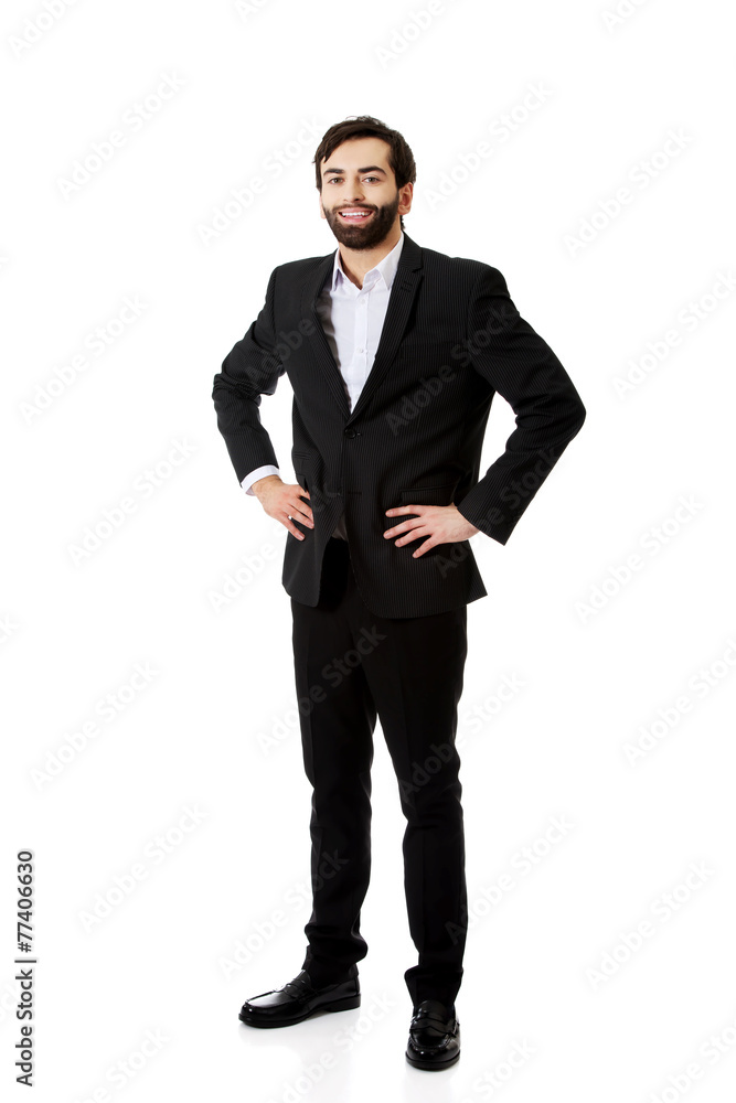 Smiling businessman with hands on hips. Smiling businessman with hands on hips.