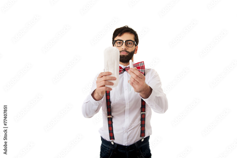 Man wearing suspenders holding menstruation pad. Man wearing suspenders holding menstruation pad.