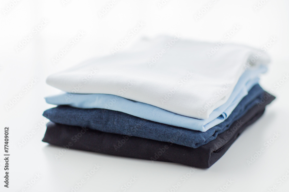 close up of ironed and folded t-shirts on table