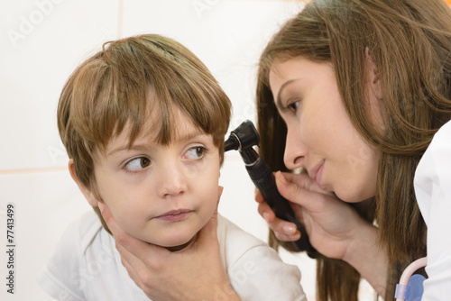 Otolaryngologist examining a kid ear