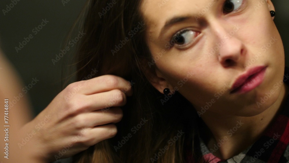 girl in front of the mirror combs her hair girl in front of the mirror combs her hair