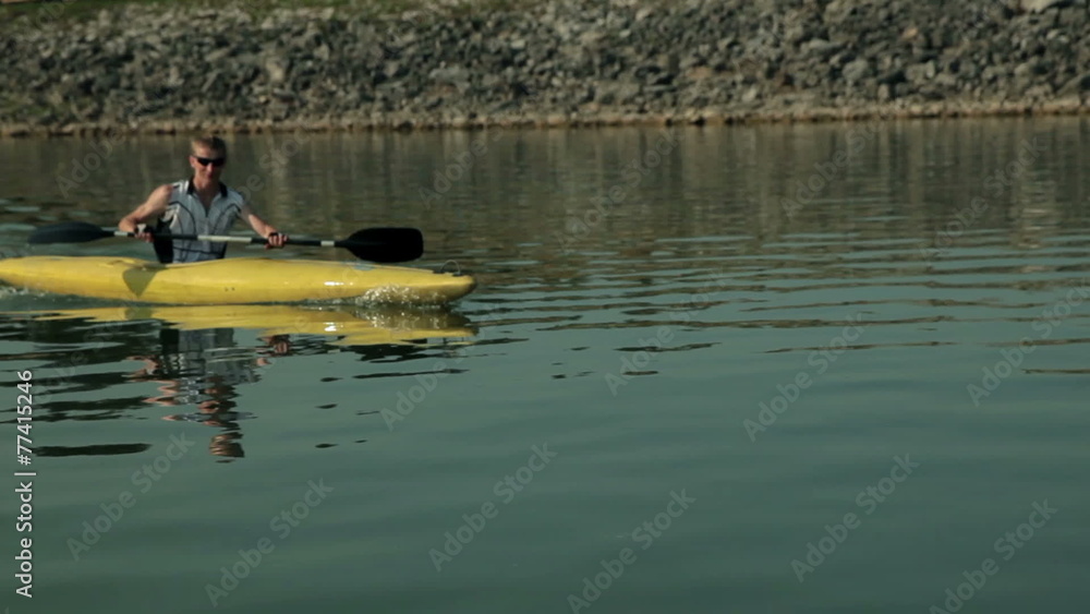 Tracking close up on kayaker enjoyin kayaking in lake Tracking close up on kayaker enjoyin kayaking in lake