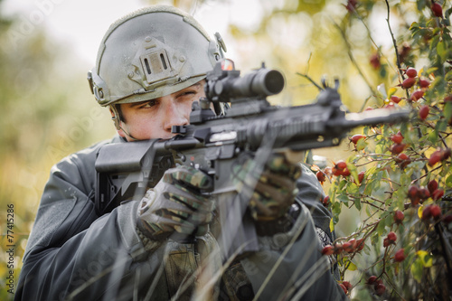 military soldier shooting an assault rifle