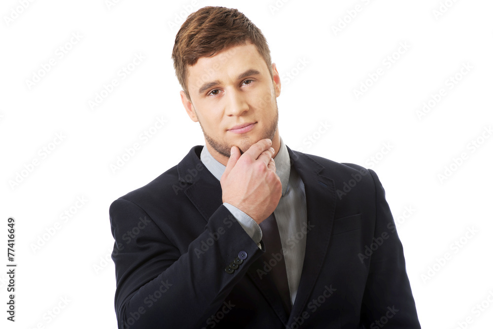 Successful businessman with finger under chin. Successful businessman with finger under chin.