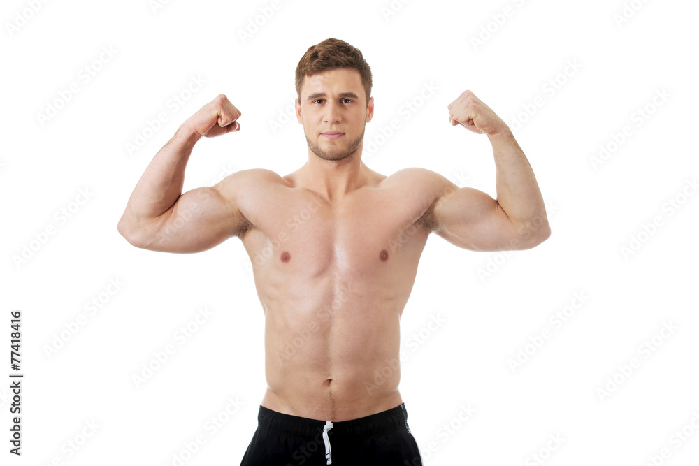 Young athletic man showing his muscles.