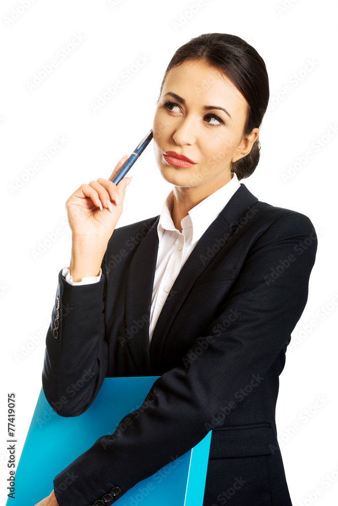 Thoughtful businesswoman holding a pen Thoughtful businesswoman holding a pen