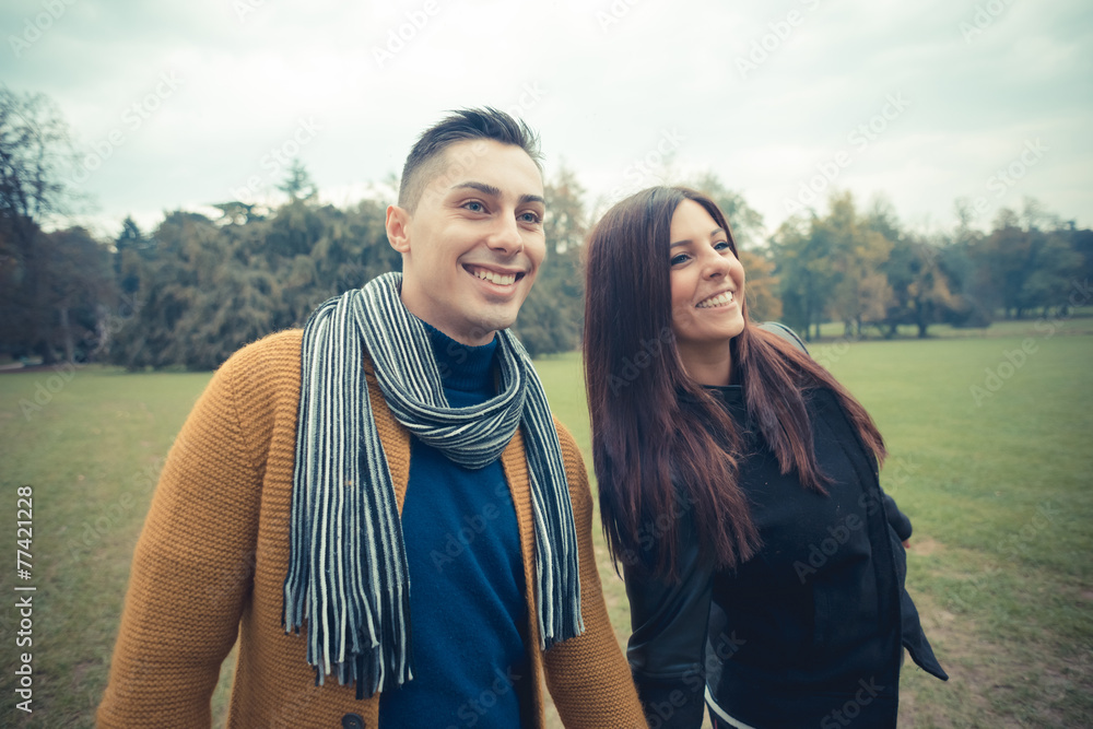 young couple in the park during autumn season outdoor