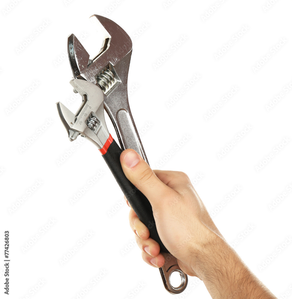 Adjustable wrenches in male hand isolated on white Adjustable wrenches in male hand isolated on white