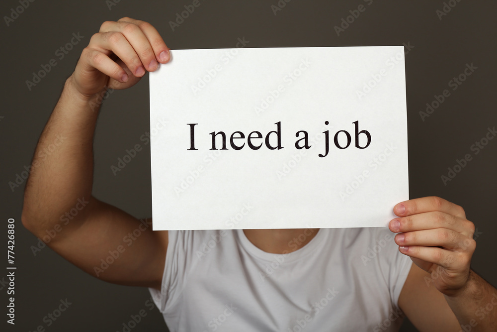 Sheet of paper with inscription I need a job in male hands Sheet of paper with inscription I need a job in male hands