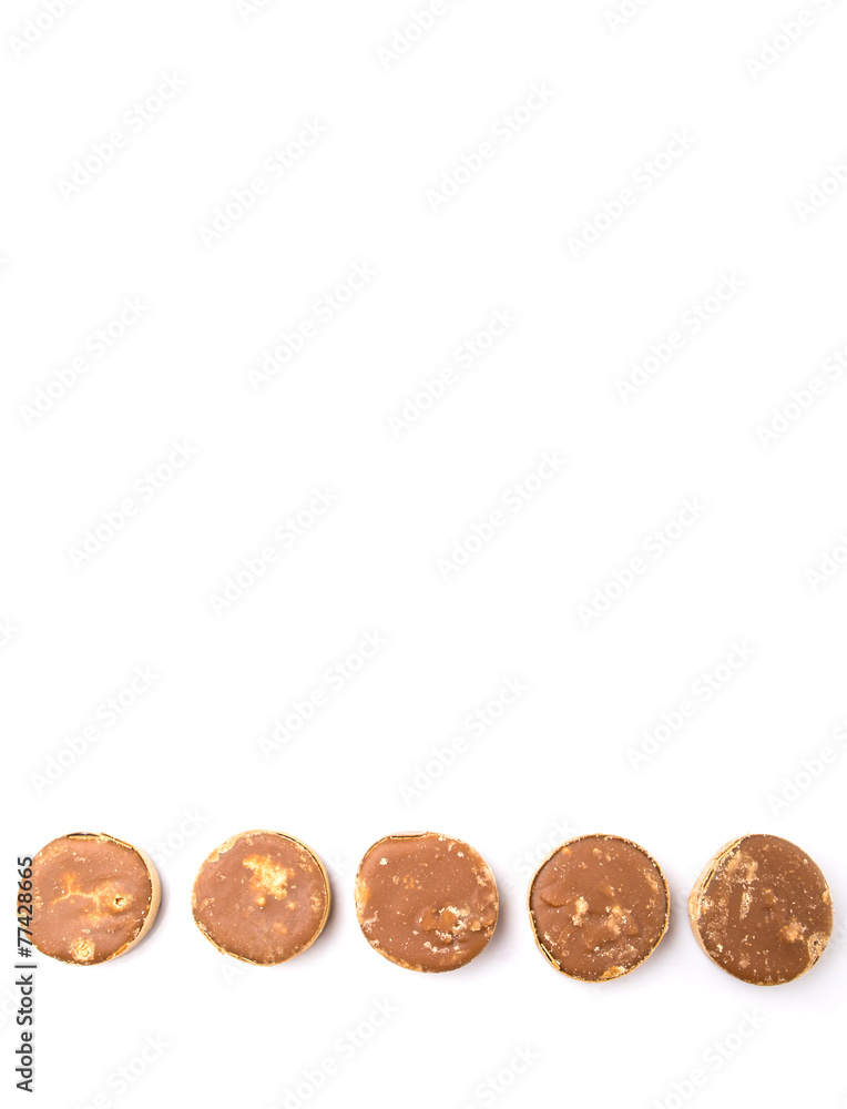 Round palm sugar over white background Round palm sugar over white background