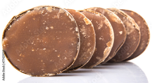 Round palm sugar over white background photo