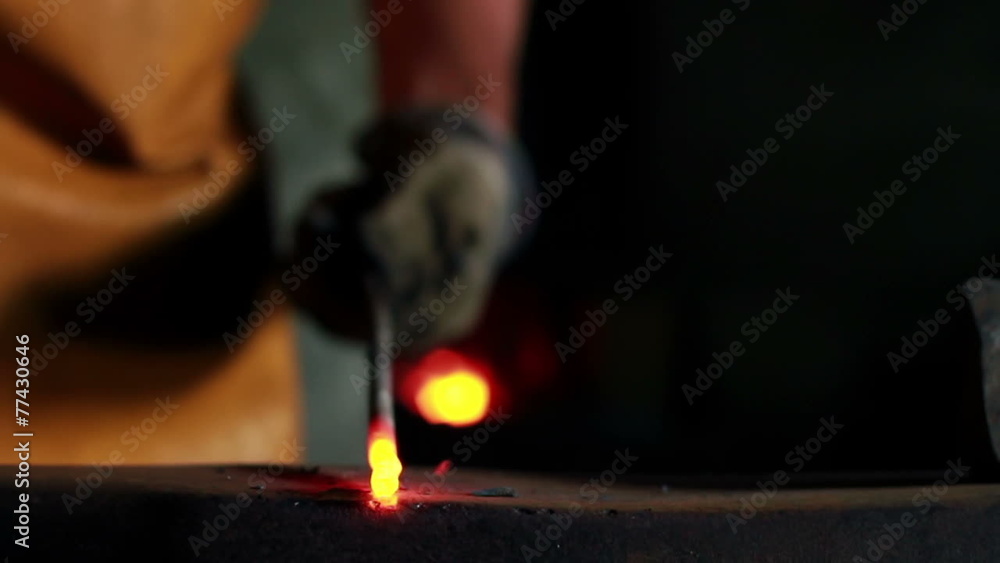 Close up slide shot of blacksmith who shapes hot steal with a hammer Close up slide shot of blacksmith who shapes hot steal with a hammer