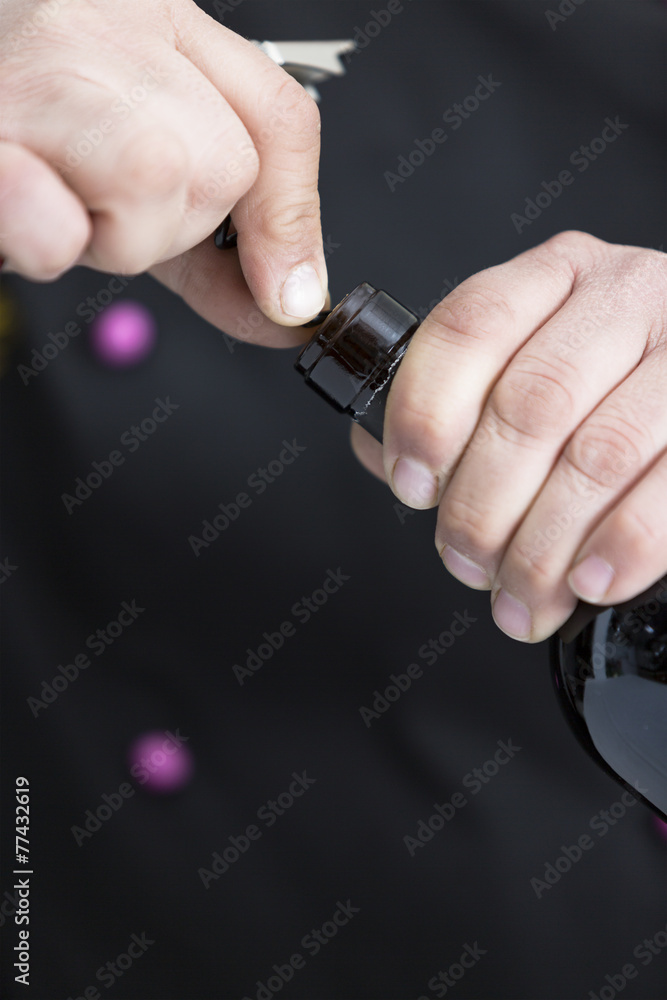 Fototapeta premium uncorking a bottle of red wine.