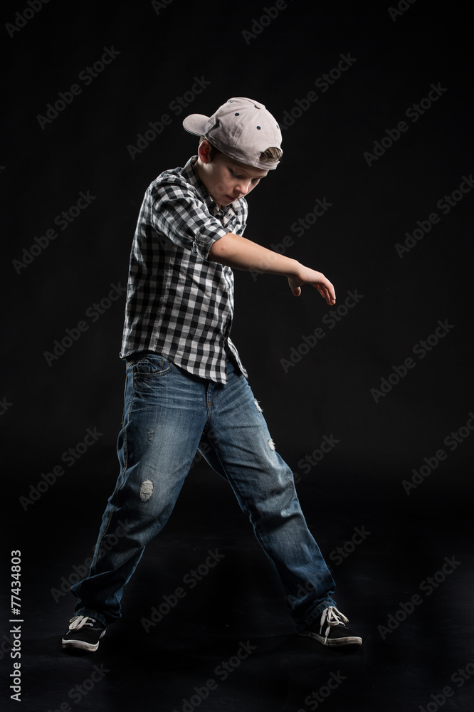 little break dancer showing his skills on black background. little break dancer showing his skills on black background.