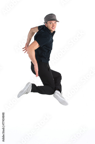 young dancer jumping on white background in studio. © BlueSkyImages