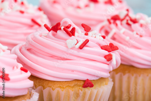 Closeup of pink Valentines Day cupcakes with sprinkles