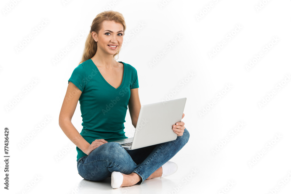 young colledge girl sitting on floor with laptop young colledge girl sitting on floor with laptop