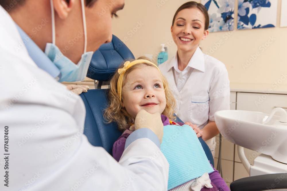 Fototapeta premium Little girl at dentist looking up and smiling.
