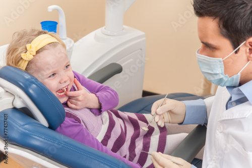 Little girl at dentist looking and smiling.