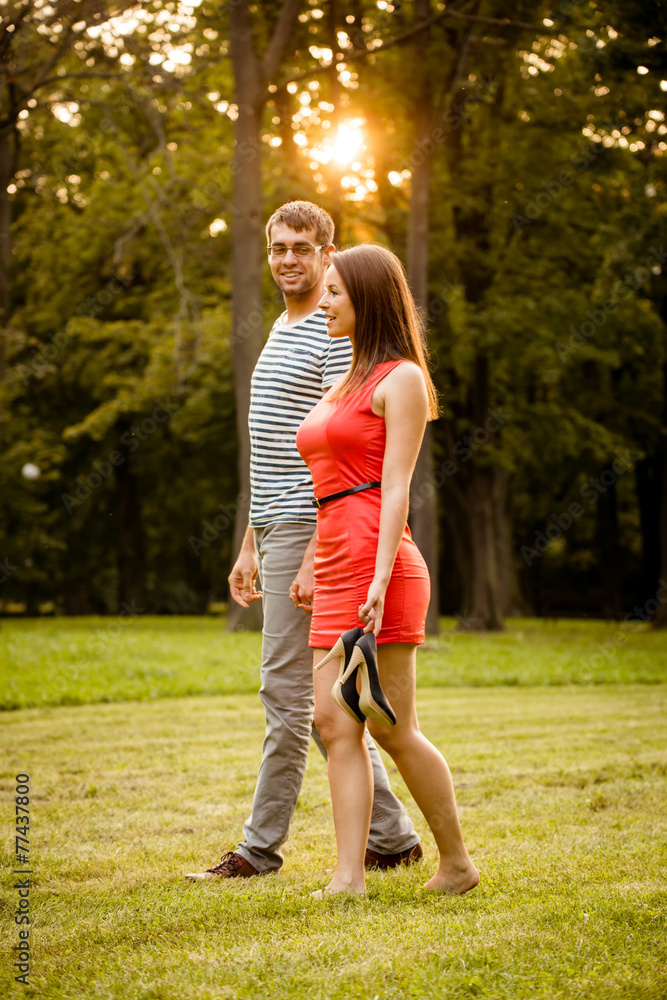 Young couple walking on grass