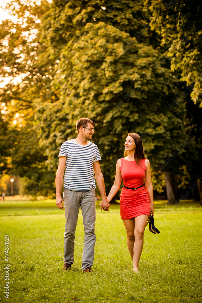 Young couple walking on grass Young couple walking on grass